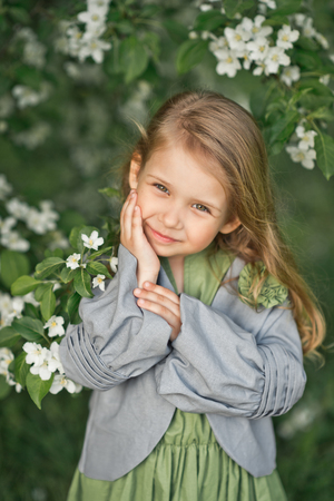 The child smiles shyly at the large portrait.の写真素材