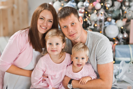 Happy family at the Christmas tree.