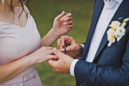 Photo embrace of the hands of the newlyweds.