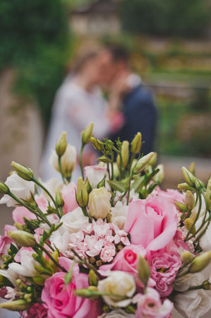 Delicate bouquet of pink and white flowers in the hands of the bride.の写真素材