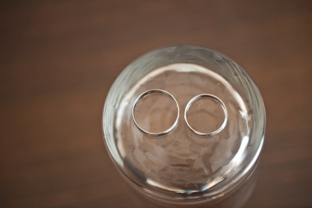 Wedding rings at the bottom of the glass.の写真素材