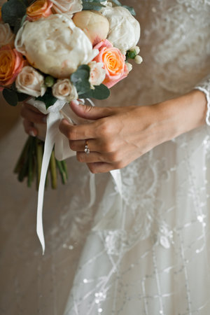 The girl is holding a beautiful bouquet in her hands.の写真素材