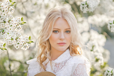 A large portrait of a blonde among flowers.