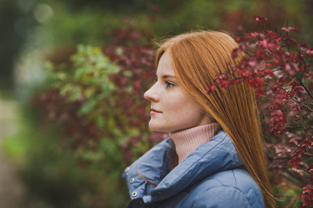 A girl in nature among the bushes.