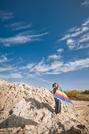 A child launches a rainbow kite.の写真素材