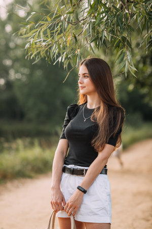 A girl with long hair and wearing a black T-shirt with short shorts.の写真素材