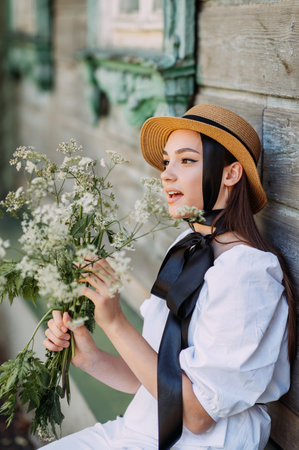 A large young female portrait in a hat and with black ribbons.の写真素材