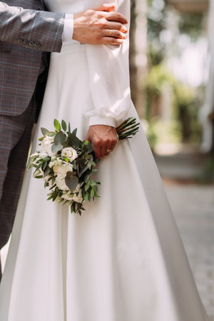 The newlyweds tenderly embrace each other in nature.の写真素材