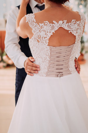 Embracing the hands of the newlyweds on a sunny summer day.の写真素材