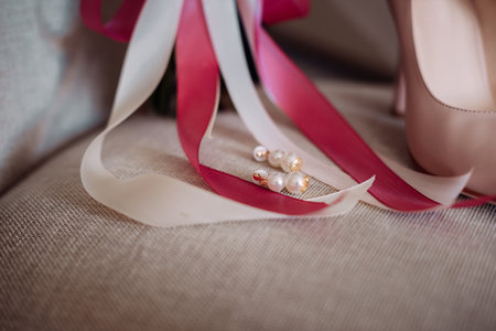 Bouquet, shoes and jewelry of the bride on the chair.の写真素材