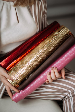 Scrolls with cover materials in the hands of a business woman.の写真素材
