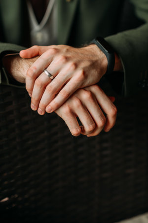 Crossed male arms on the back of the chair.の写真素材