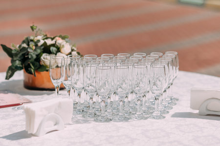 Rows of champagne glasses on the festive table.の写真素材