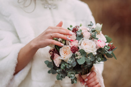 A delicate bouquet in the hands of the bride.