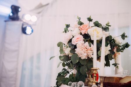 Elements of the wedding decor of the hall in the form of racks and tables with delicacies.の写真素材