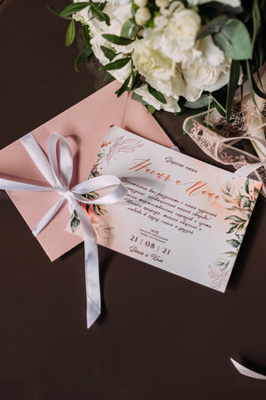 Bouquet, invitation and other jewelry of the bride for the wedding.