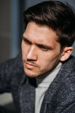 He is indoors and the focus is on his facial features including his beard, moustache, and skin.の写真素材