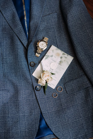 n it. 5213 The person is indoors and the suit appears to be blue.