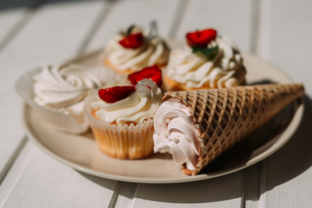 d frozen desserts. 5280 The plate is decorated with a variety of toppings like icing, coconut cream, and strawberries.の写真素材