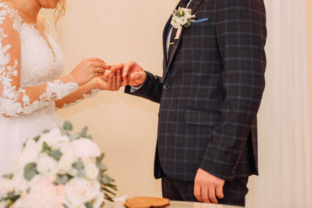 The woman is wearing a bridal dress. The setting seems to be a wedding ceremony.