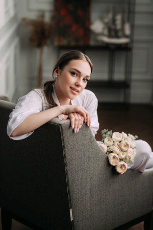 The person appears to be a woman, possibly at a wedding, sitting on a chair.の写真素材