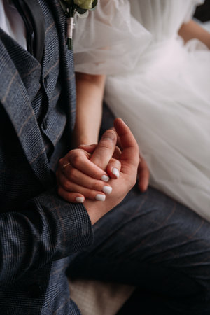 The individual appears to be a bride, and the photo was taken indoors. Additional details include embellishments on the dress and a head covering.の写真素材