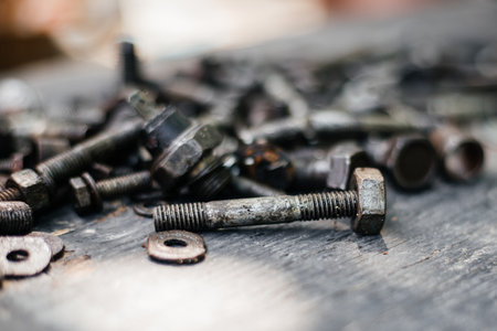 An old bolt in mazut with a blurred background and a place for textの写真素材