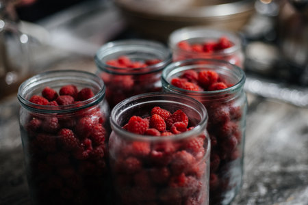 Raspberries in a glass jar. Preparation for making jam or compote. Home canningの写真素材