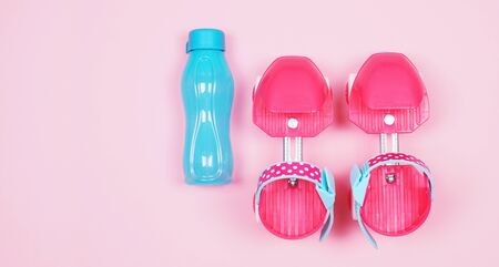 Children's inline skates are pink. Four wheel casters for a girl. Top view