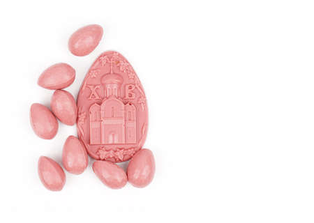 Beautiful Easter composition with Easter cake, chocolate eggs and a hare on a colored background.