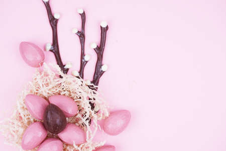 Beautiful Easter composition with Easter cake, chocolate eggs and a hare on a colored background.の写真素材