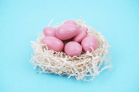 Beautiful Easter composition with Easter cake, chocolate eggs and a hare on a colored background.の写真素材