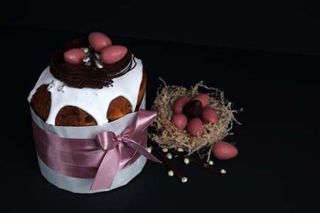 Composition of chocolate figurines. Chocolate bunny. Chocolate eggs on a colored background. Place...