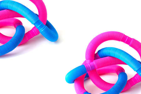 pop tube trending toy of 2021.anti-stress sensory plastic toy from a tube of pink and blue color on an isolated white background. Corrugated metamarphosis. Flat lay with place for text.の写真素材