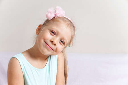 Portrait of a happy smiling child. Little girl model. Studio photo of a cute baby.の写真素材