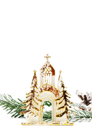 Christmas card on an isolated white background with a golden temple and a spruce branch sprinkled with snow. Happy new year 2022 greetings. Copy space. Flat layの写真素材
