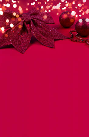 Copy space bright pink greeting card Happy New Year and Merry Christmas. Background for text with Christmas decorations and bokeh in gold color. 2022. text for congratulations. Vertical formatの写真素材