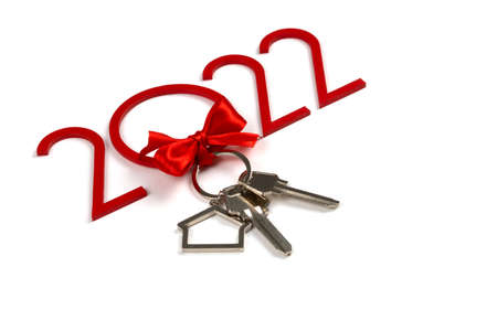 Keys with a red bow. New Years gift for 2022. Christmas. Buying a property. Mortgage. Investmentsの写真素材