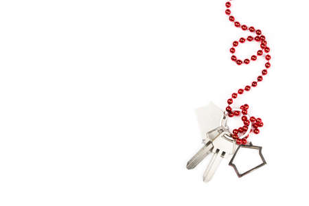 New Year and Christmas background 2022 with keys and with a red bow. Keychain house with keys on an...