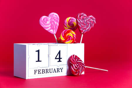 Valentines day red, fuchsia background eternal calendar white block with the date February 14, sweet...