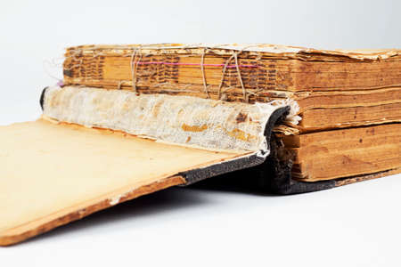 Opening of the Old Ancient Big Book. Old book on an isolated white background. Open book. The concept of the history of typography. Antiques.の写真素材
