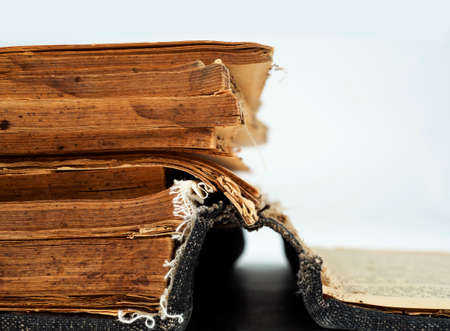 ancient old hardcover book with crumpled, old, yellow pages. History of book culture. tradition of...