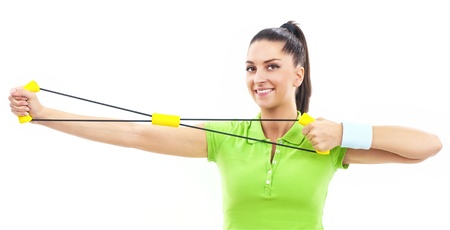 Young beautiful woman during fitness with expanderの写真素材