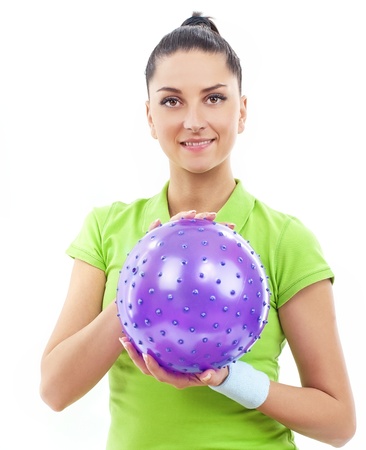 Smiling brunette woman with rubber ball, isolatedの写真素材
