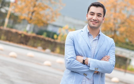 Smiling bussinesman with crossed arms, outdoor - outsideの写真素材
