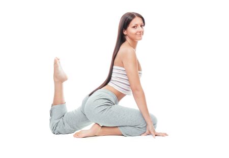 Attractive healthy young woman stretching gym, fitness female isolated on whiteの写真素材