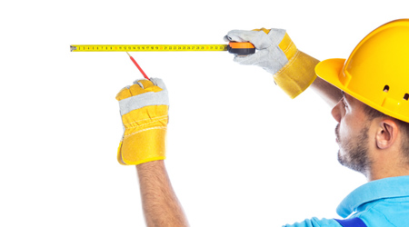Back view of a builder using measuring tape, isolated on white background