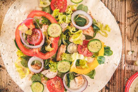 Top view prepaired delicious tortillas wraps with chicken and vegetables - saladの写真素材