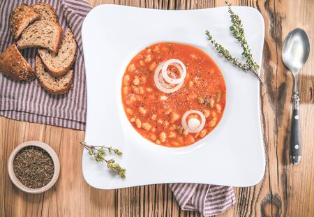 Bean soup with bread and spoon on wooden table. Topview. Delicious dinnerの写真素材