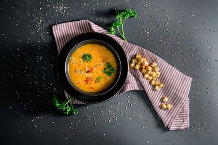Potato soup with vegetables isolated on dark gray black background. Served healthy food or lunch . Top viewの写真素材